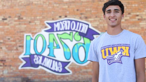 Guy in front of Salina sign